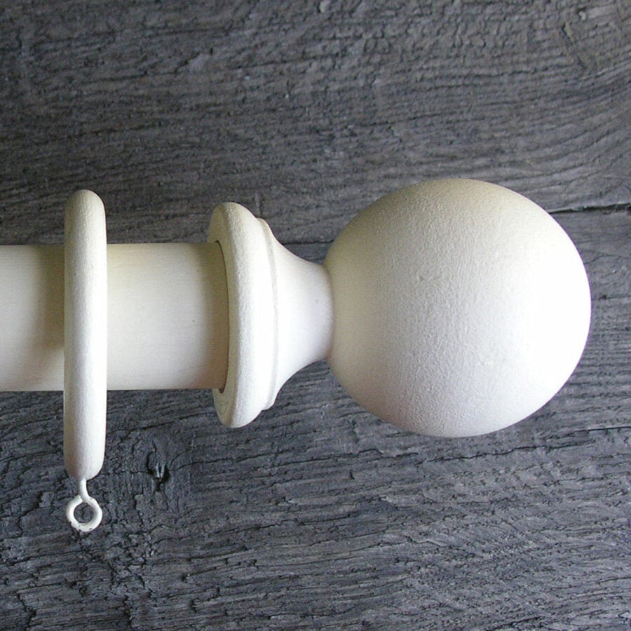 a painted wooden curtain pole