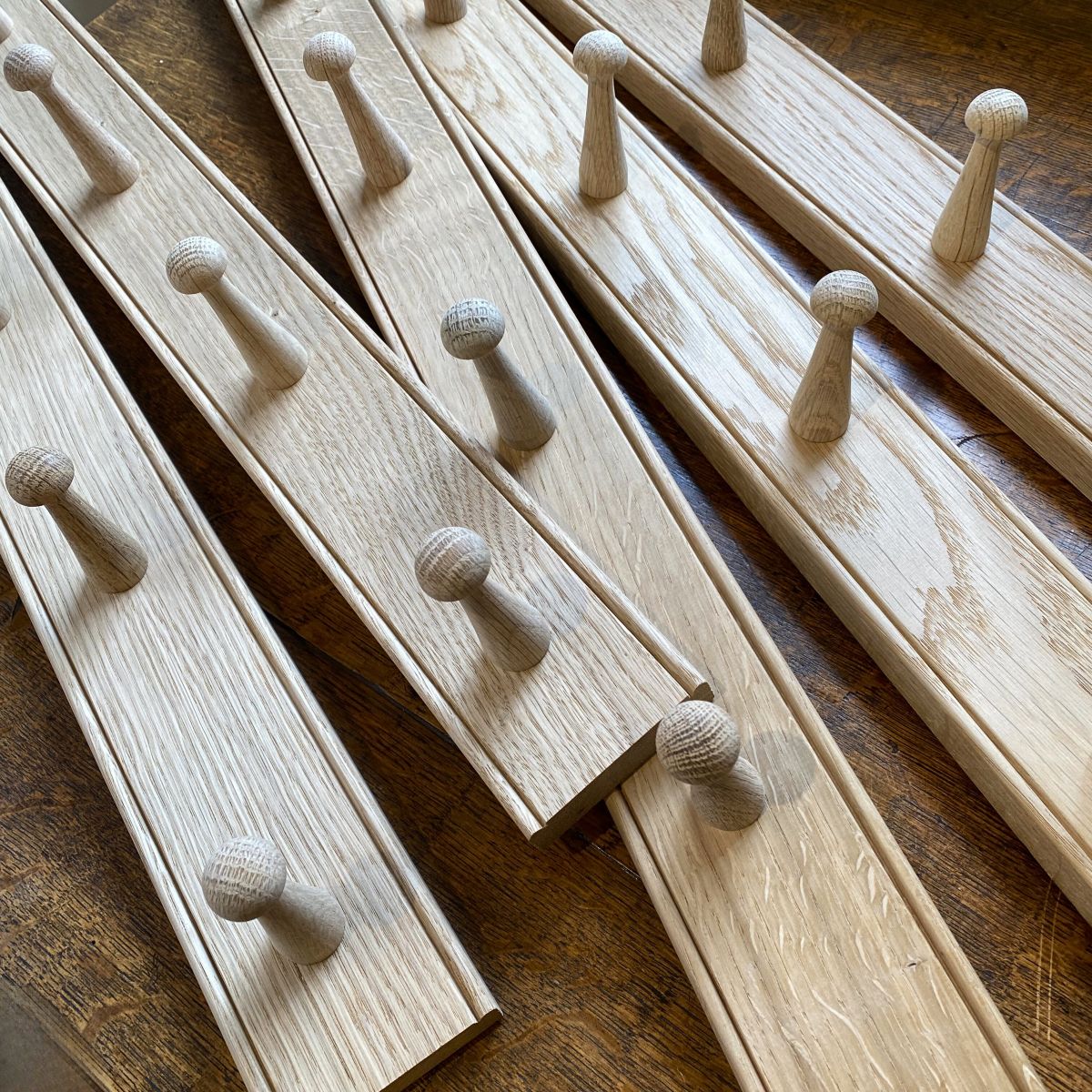 A stack of oak hook rails from Tinsmiths
