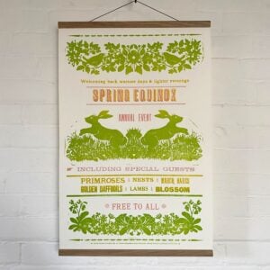 Sophie Elm Design Spring Equinox Letterpress poster hanging on a white brick wall.