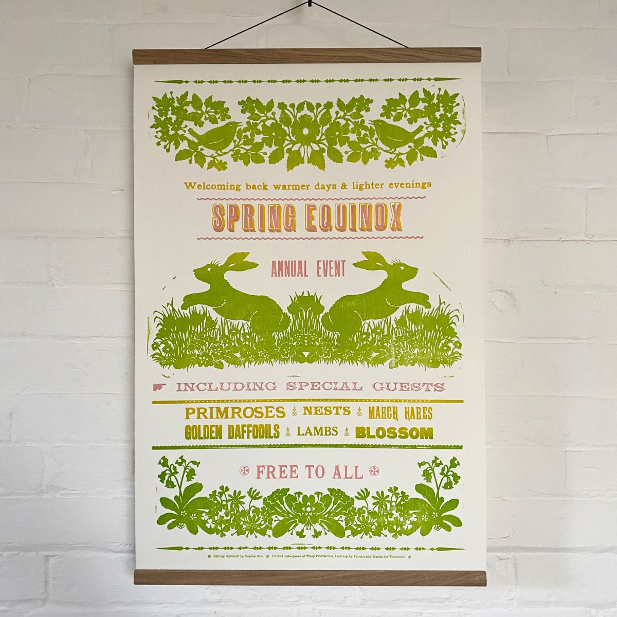 Sophie Elm Design Spring Equinox Letterpress poster hanging on a white brick wall.