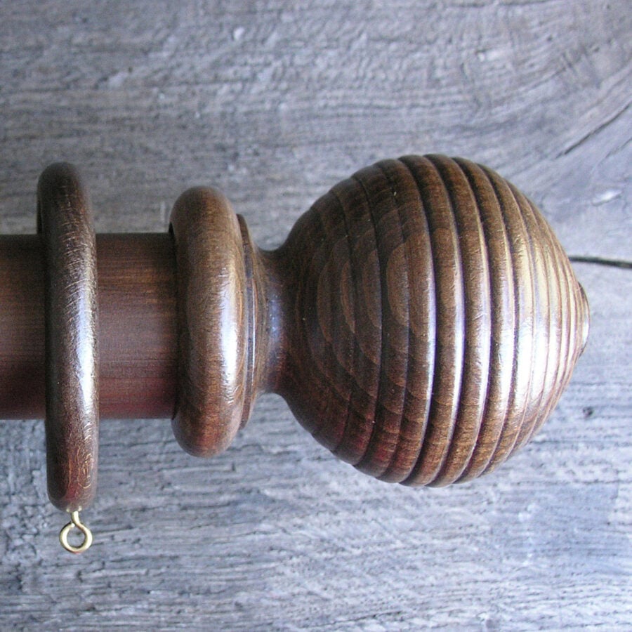 a 2" diameter walnut curtain pole
