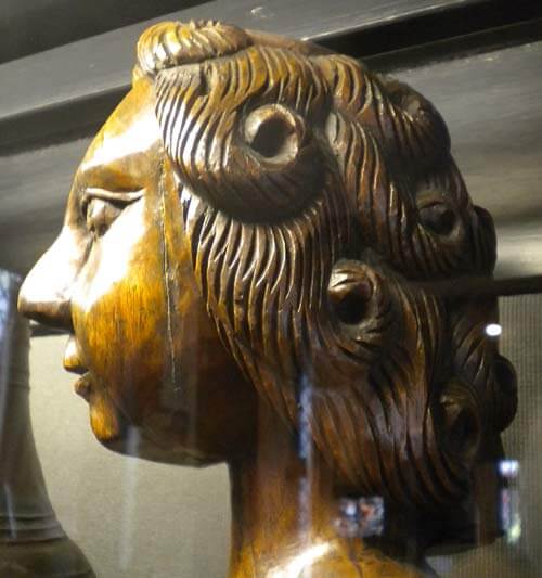 Whilst the elm torsos of these figures are completely smooth, the artist went to town on their coiffure.