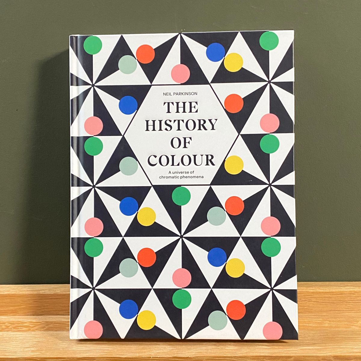 Hardback book with colourful geometric cover about history of colour