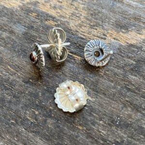 Silver disc earrings with citrine centre on a wooden background