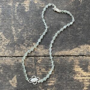 Amethyst & Silver beaded necklace on a wooden background