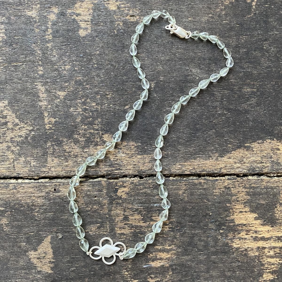 Amethyst & Silver beaded necklace on a wooden background