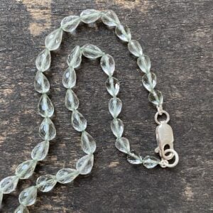 Amethyst & Silver beaded necklace on a wooden background