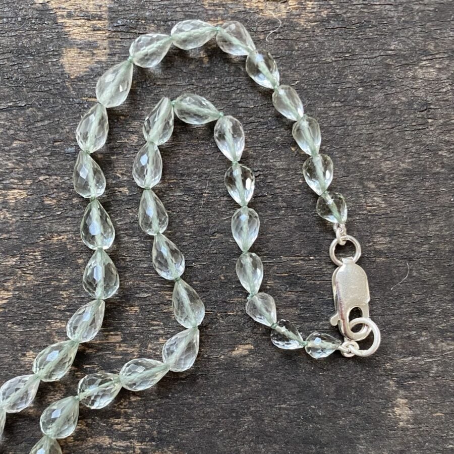 Amethyst & Silver beaded necklace on a wooden background