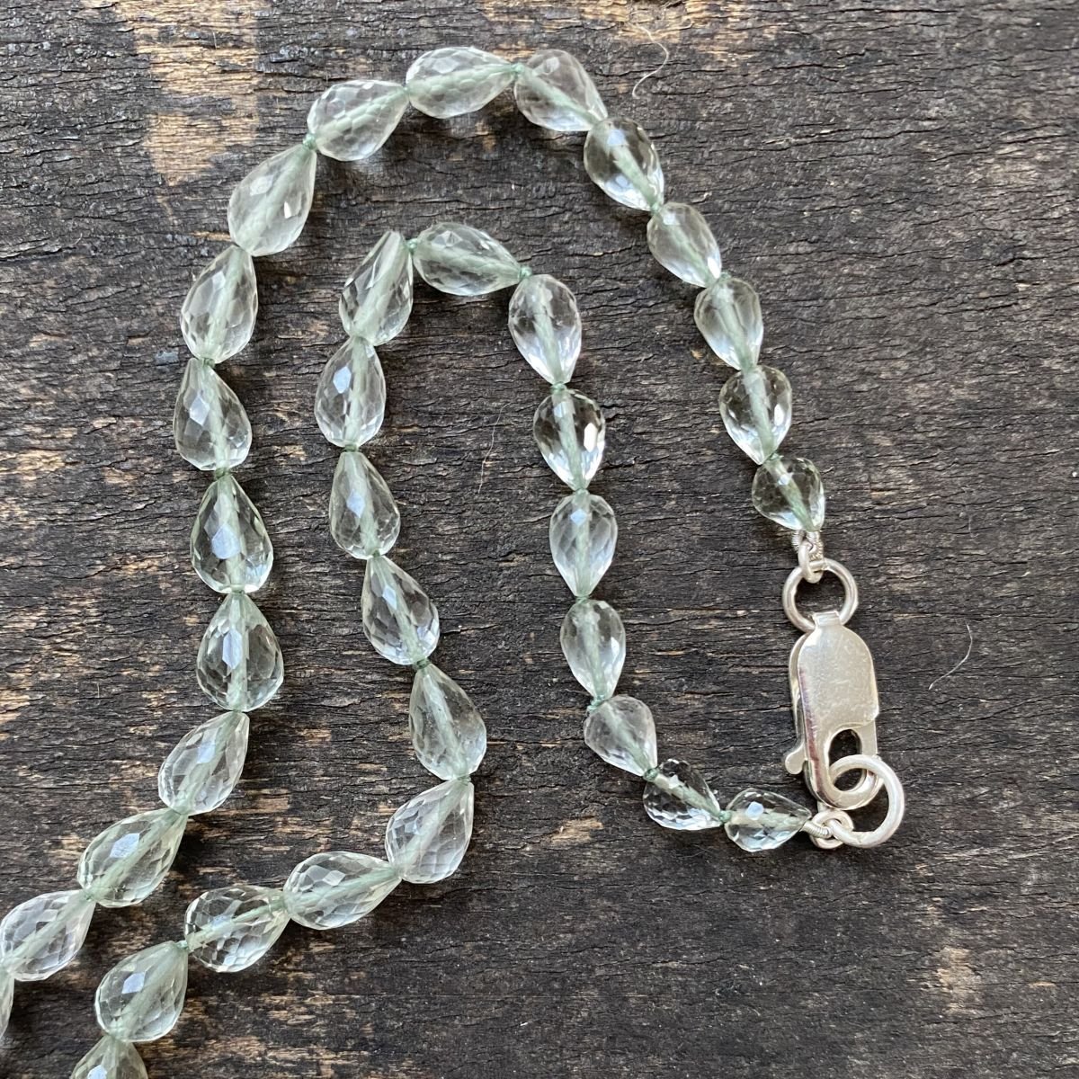 Amethyst & Silver beaded necklace on a wooden background