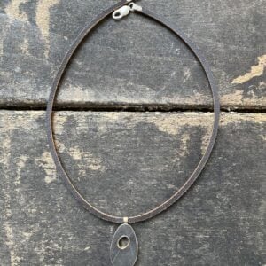 Silver pendant necklace on a wooden background