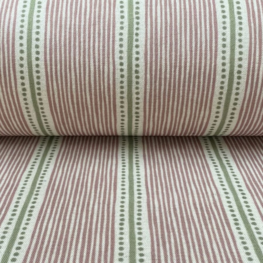 Pink & Green striped fabric on a roll at an angle