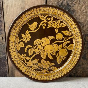 Katie B Morgan slipware Plate against a wooden panelled wall.