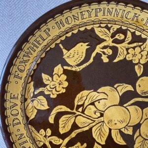 Detail of a Katie B Morgan slipware Plate on a tablecloth