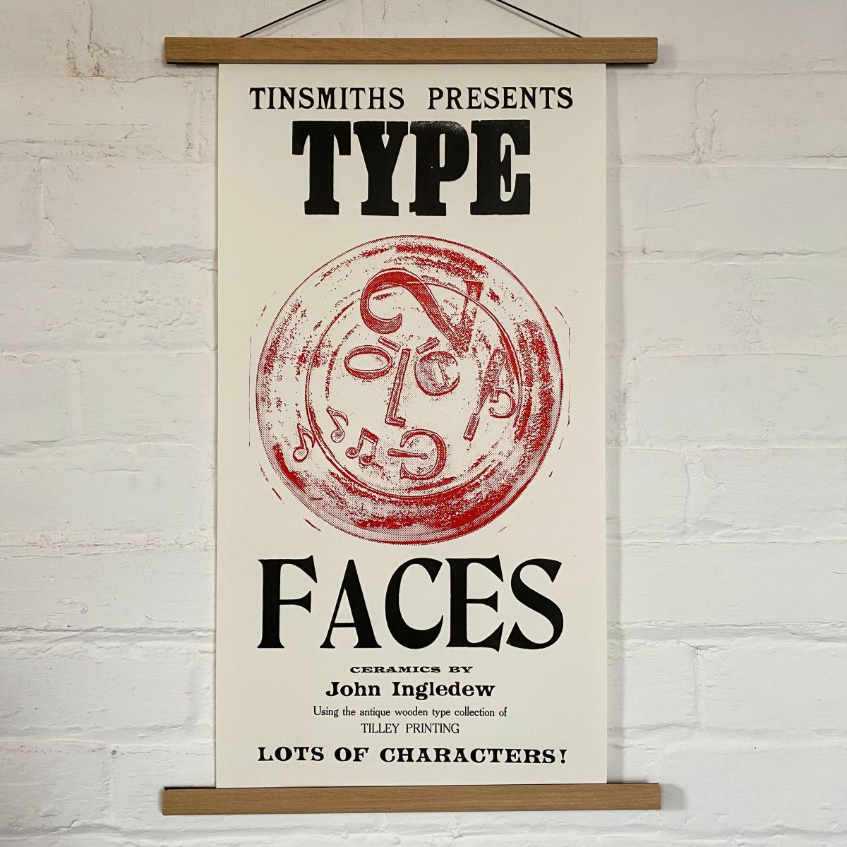 Type Faces Letterpress Poster on a white wall