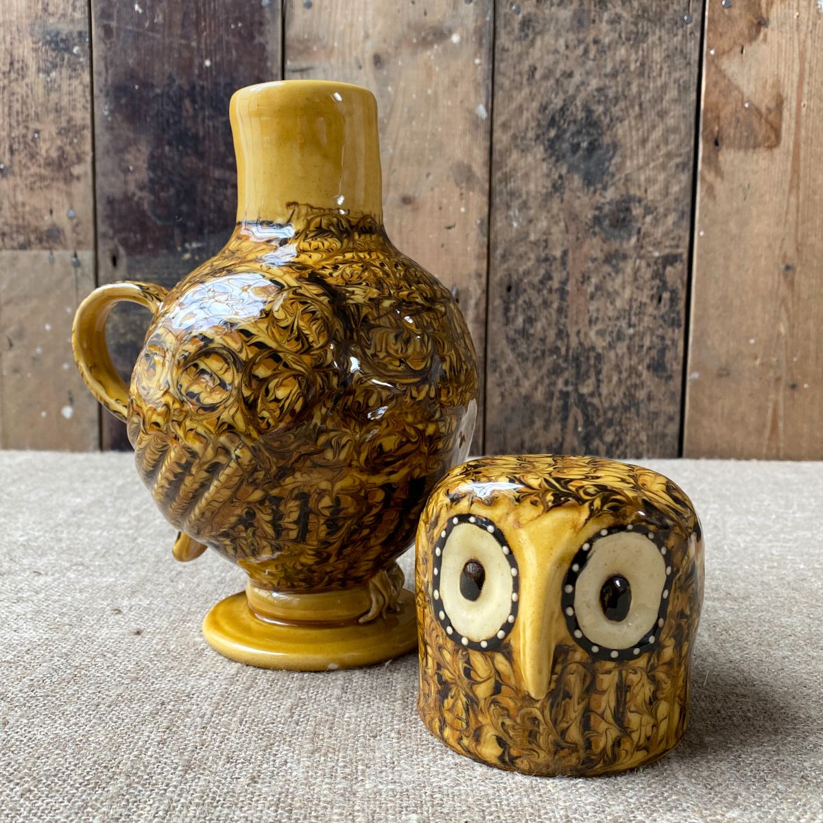 Carole Glover slipware glazed Ozzy Owl against a wooden background