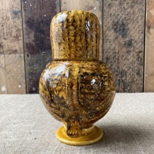 Carole Glover slipware glazed Ozzy Owl against a wooden background