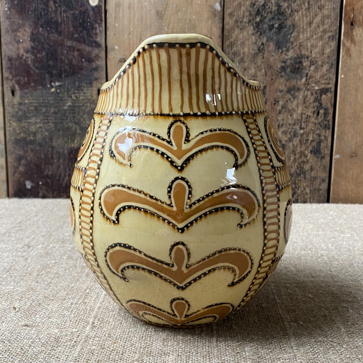Front View Carole Glover Slipware Noggin Jug against wooden background