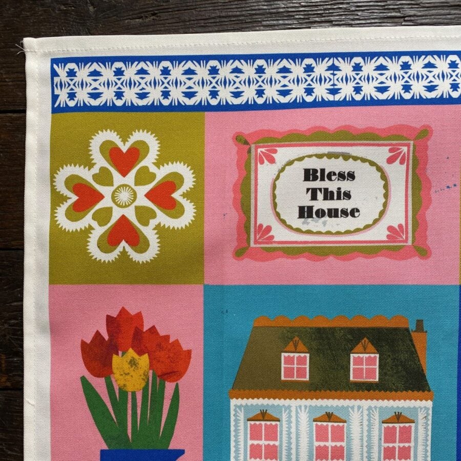 Illustrated Teatowel by Marion Elliot of a house, tulips and a dancing figure border