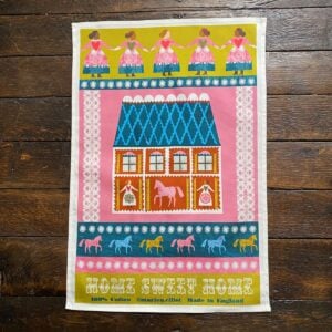 Illustrated Teatowel by Marion Elliot of a house, dancing women and horses