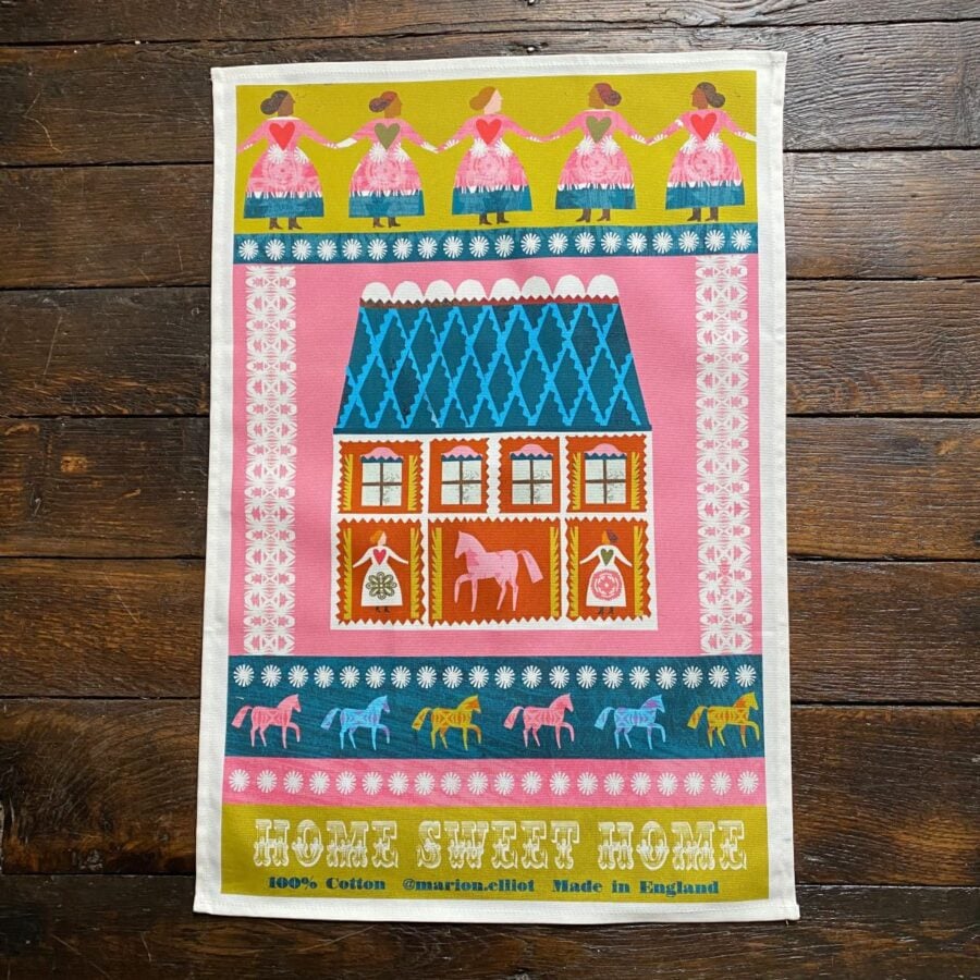 Illustrated Teatowel by Marion Elliot of a house, dancing women and horses