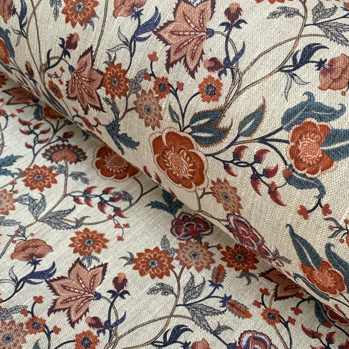 Melody Linen Print fabric in teal & orange on a roll