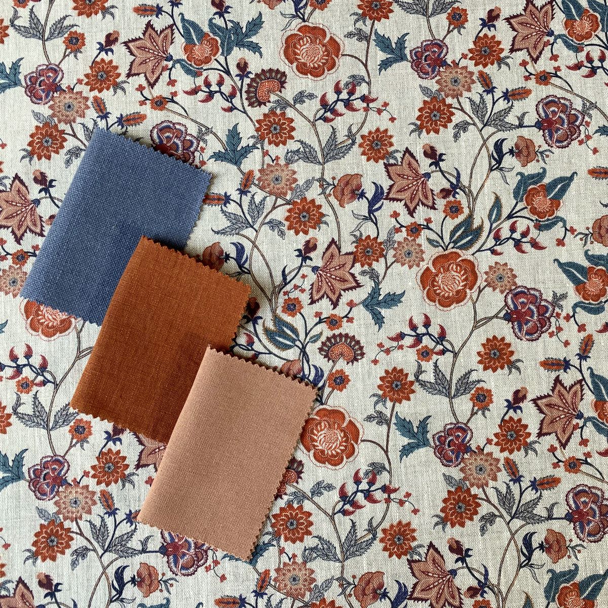 Melody Linen Print fabric in teal & orange on a roll