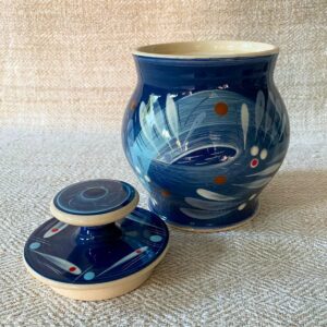 RAMP Ceramics earthenware caddy jar in a blue abstract design on a cream textile backdrop.