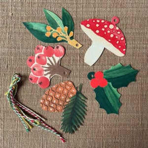 Hadley set of 5 Festive Gift Tags on pink cloth background