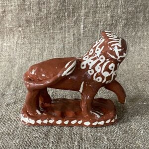 Emma Carlow upright lion pottery whistle against fabric background