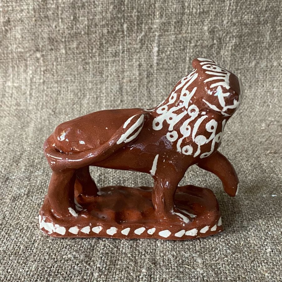 Emma Carlow upright lion pottery whistle against fabric background
