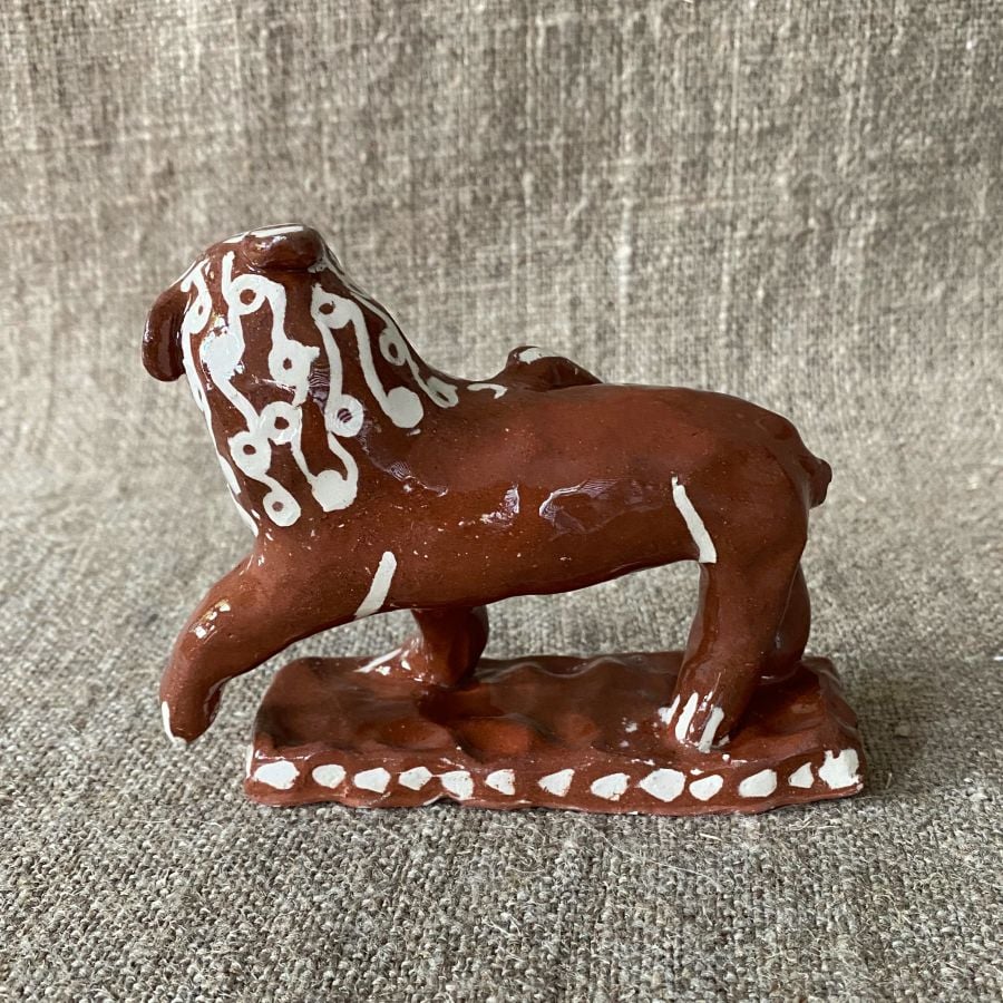 Emma Carlow upright lion pottery whistle against fabric background