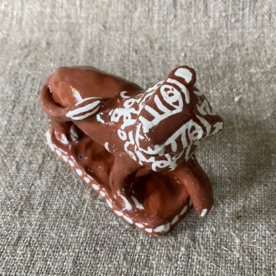 Emma Carlow upright lion pottery whistle against fabric background