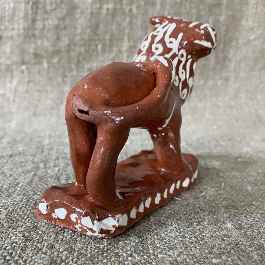 Emma Carlow upright lion pottery whistle against fabric background
