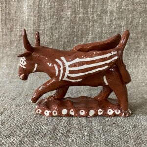 Emma Carlow winged bull pottery whistle against fabric background