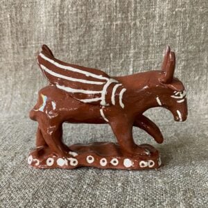Emma Carlow winged bull pottery whistle against fabric background