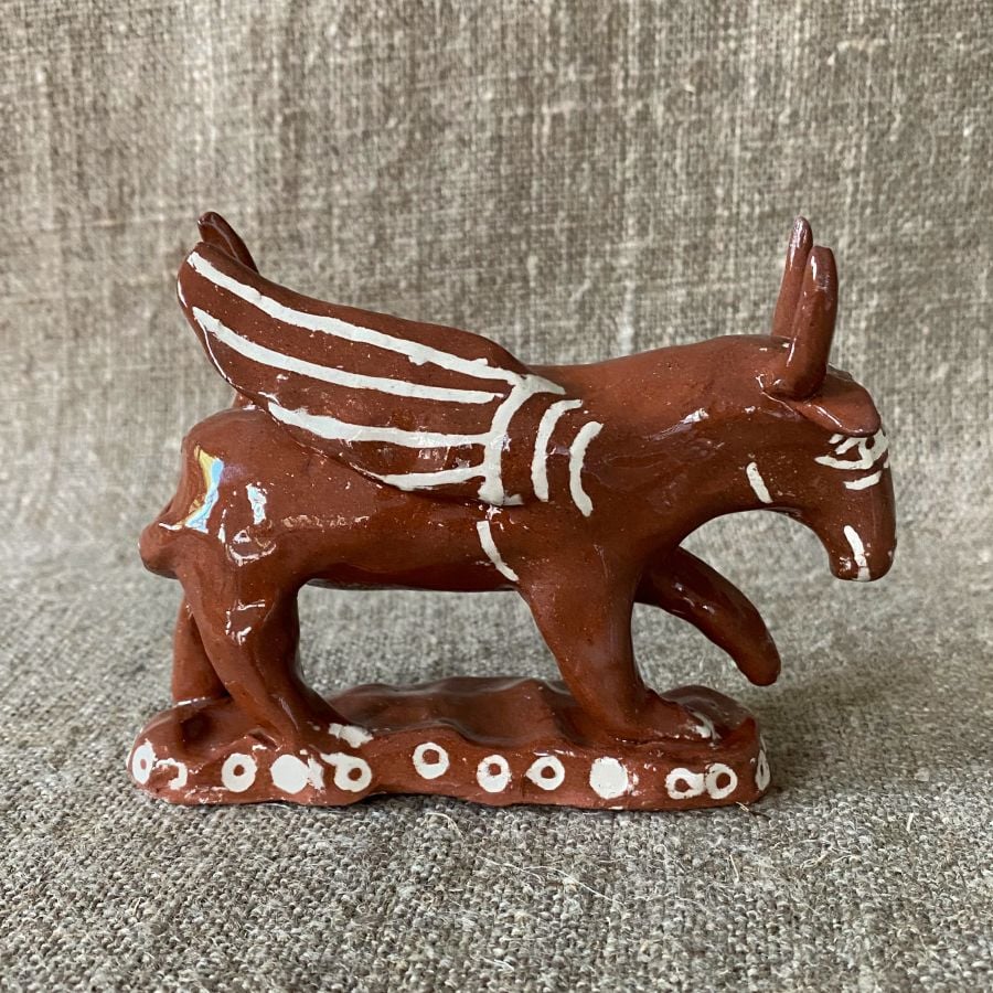 Emma Carlow winged bull pottery whistle against fabric background