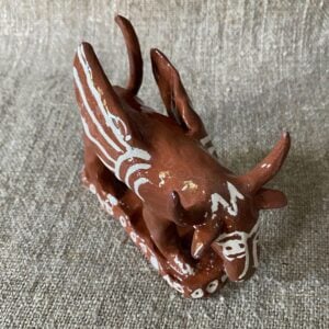 Emma Carlow winged bull pottery whistle against fabric background