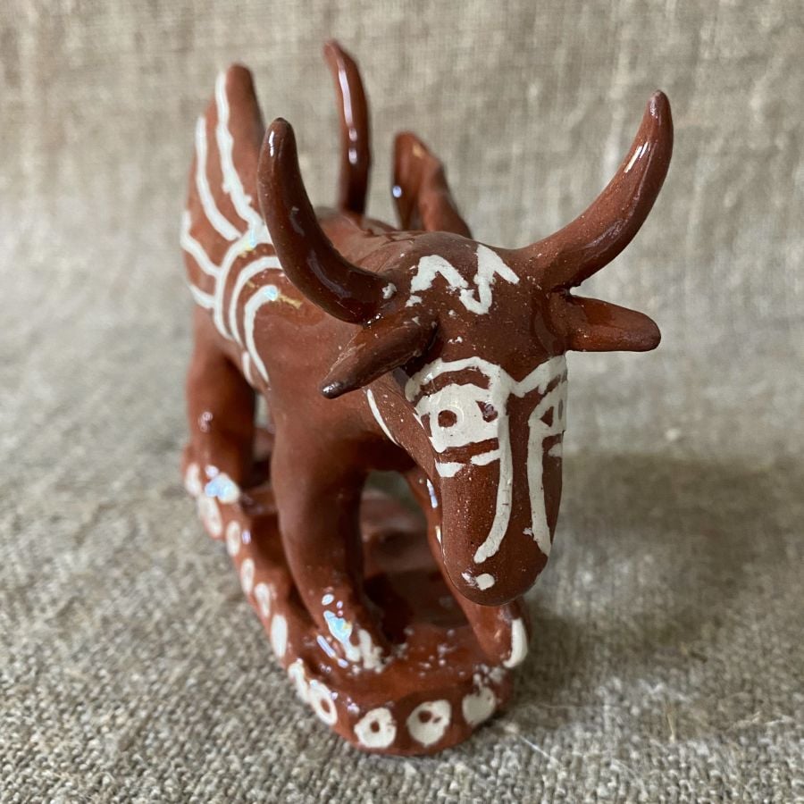 Emma Carlow winged bull pottery whistle against fabric background