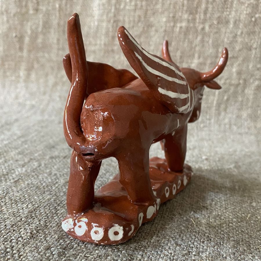 Emma Carlow winged bull pottery whistle against fabric background