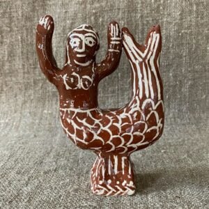 Emma Carlow mermaid pottery whistle against fabric background