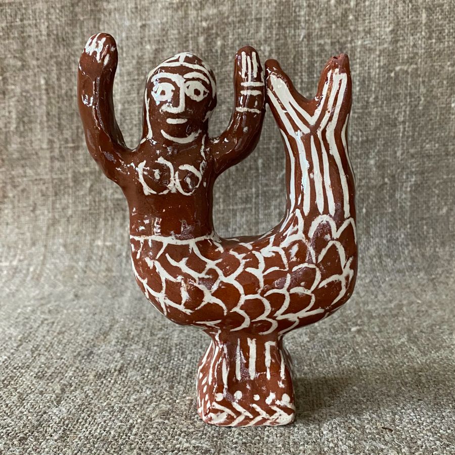 Emma Carlow mermaid pottery whistle against fabric background
