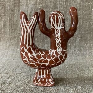 Emma Carlow mermaid pottery whistle against fabric background