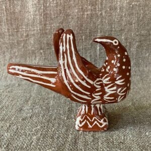 Emma Carlow bird pottery whistle against fabric background