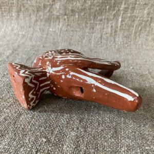 Emma Carlow bird pottery whistle against fabric background