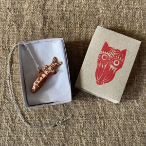 Emma Carlow Tiny clay whistle on a fabric background - Fish