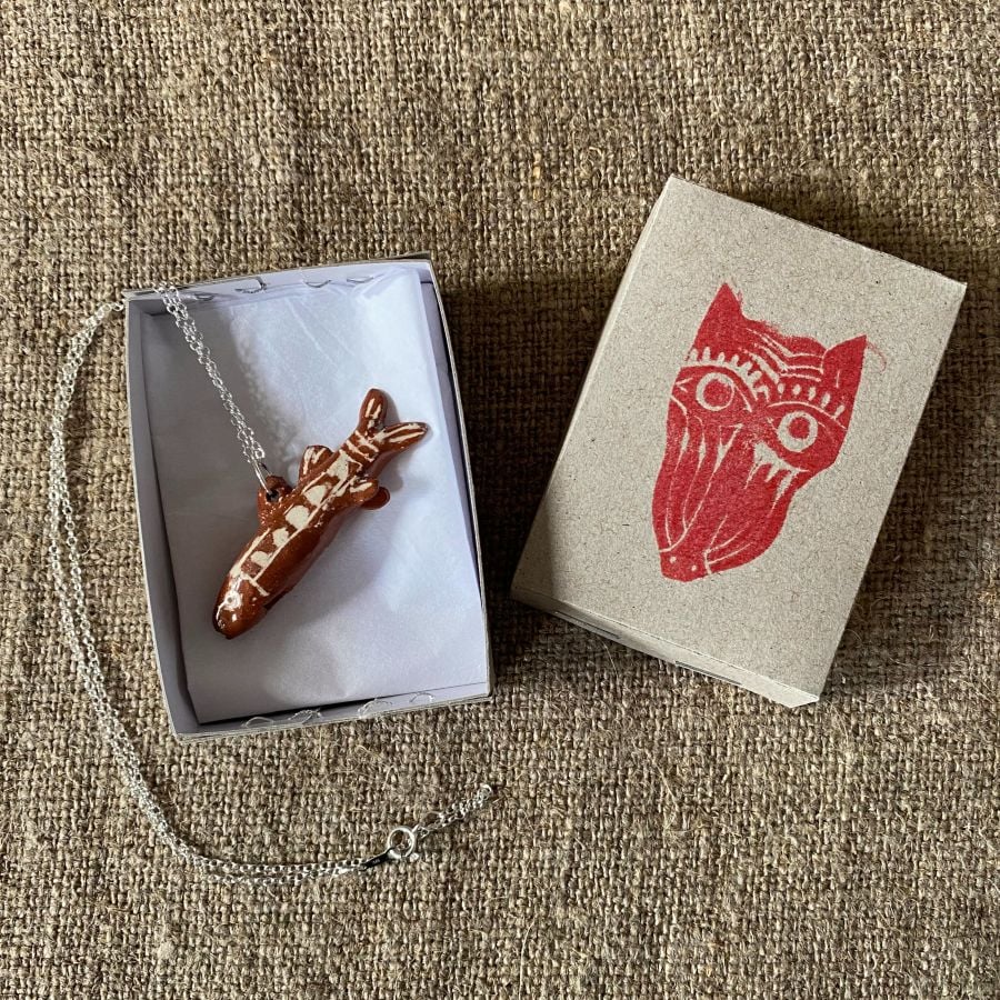Emma Carlow Tiny clay whistle on a fabric background - Fish