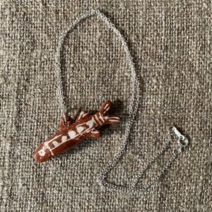 Emma Carlow Tiny clay whistle on a fabric background - Fish