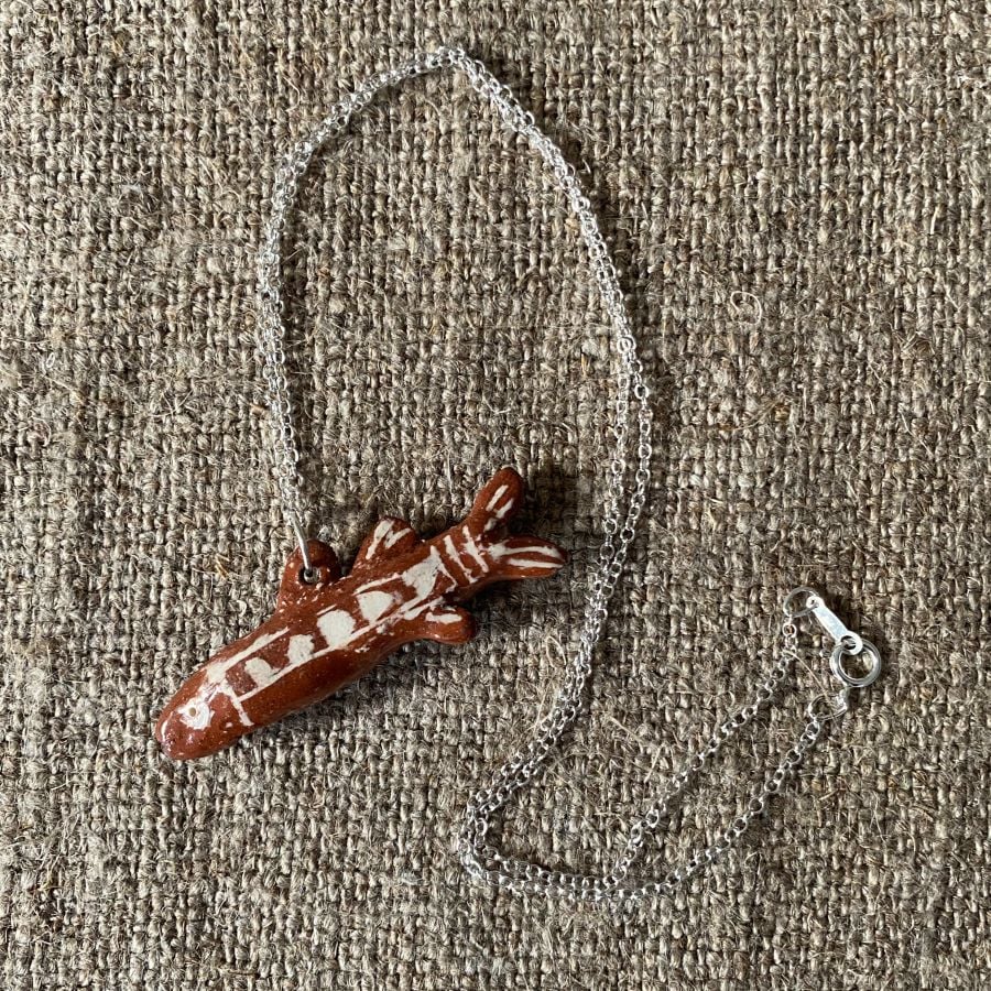 Emma Carlow Tiny clay whistle on a fabric background - Fish