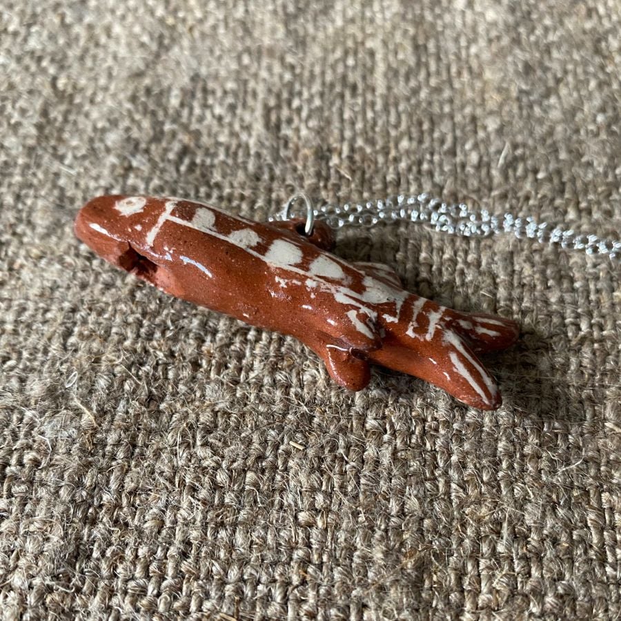 Emma Carlow Tiny clay whistle on a fabric background - Fish