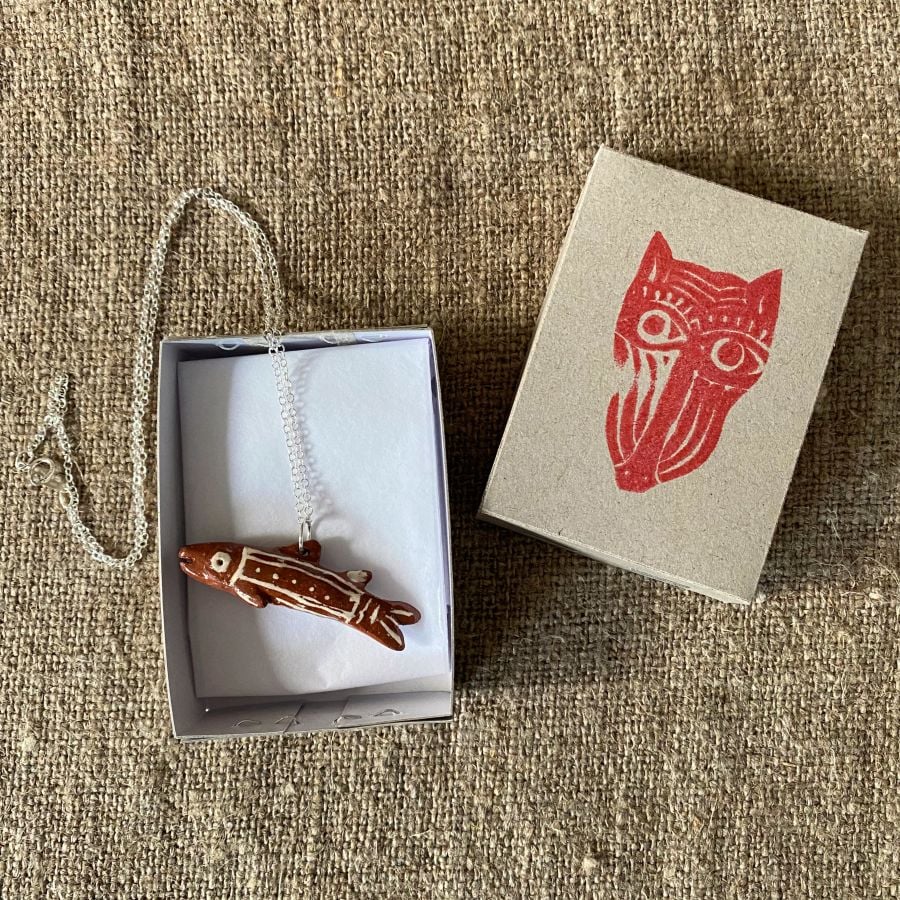 Emma Carlow Tiny clay whistle on a fabric background - Fish